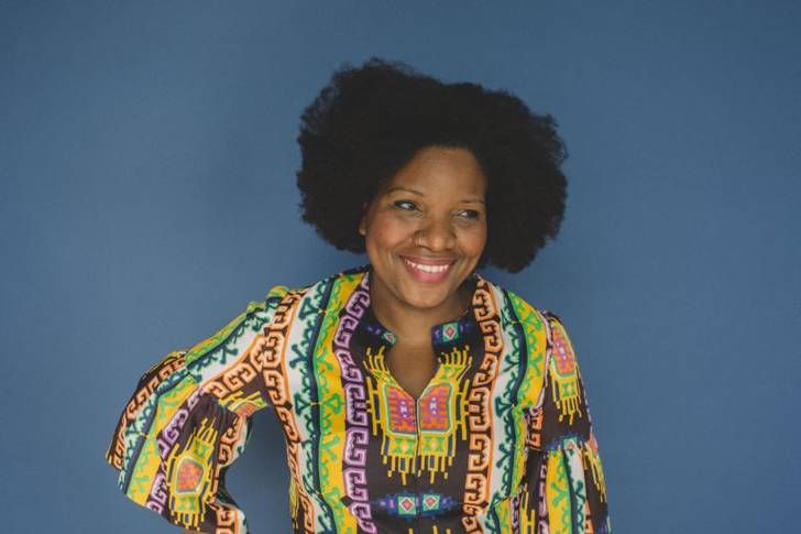 Photograph of a woman in a colorful shirt.